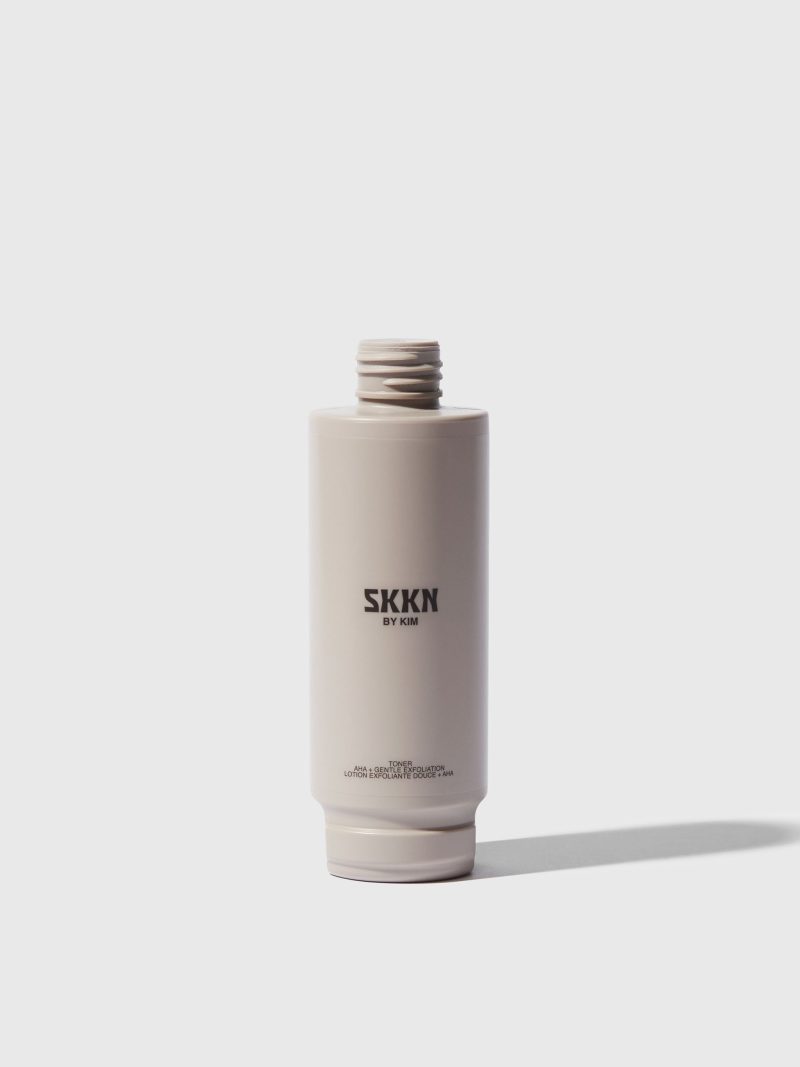 Opened bottle of SKKN BY KIM Toner Pore Reducing next to cap | Refill